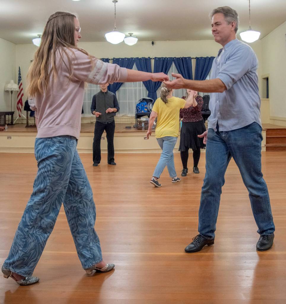 Sequim Gazette photo by Emily Matthiessen/ Sequim Ballroom students Saria Weller and Philip Wade practice Swing dancing at the Old Dungeness Schoolhouse on Thursday night.