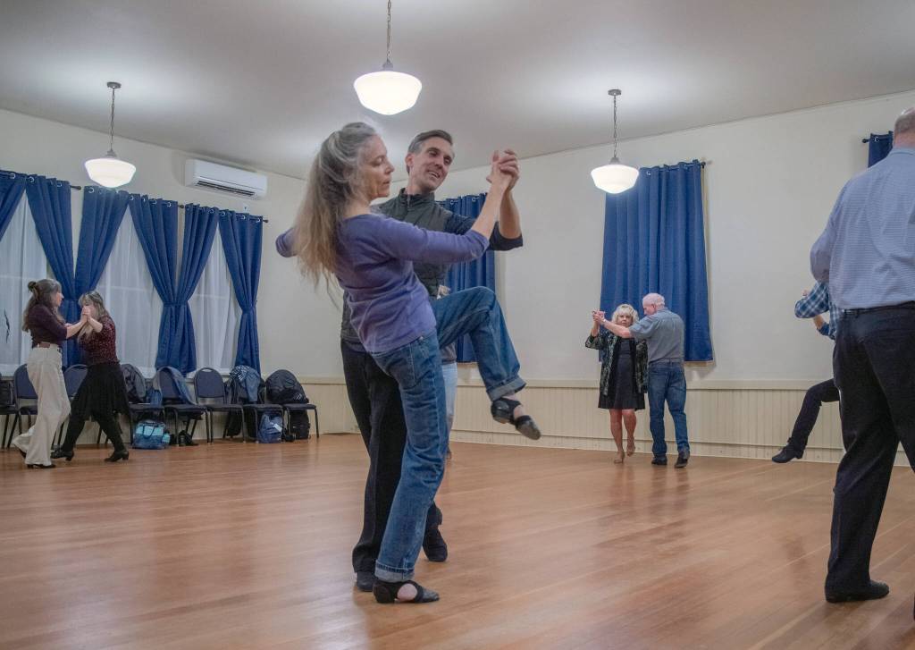 Sequim Gazette photos by Emily Matthiessen
Competitive dance champion and ballroom dance instructor Werner Figar leads student Debra Van Dusen in a waltz, while other students circle the room at Old Dungeness Schoolhouse.