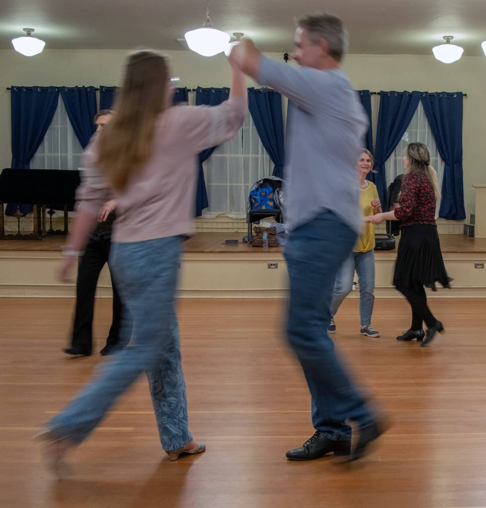Sequim Gazette photo by Emily Matthiessen/ Sequim Ballroom students Saria Weller and Philip Wade practice Swing dancing at the Old Dungeness Schoolhouse on Thursday night.