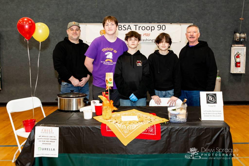 Photo courtesy Dewi Sprague Photography/ Members of Boy Scout Troop 90, from left, assistant scoutmaster Tim Disinski, scouts Brayden Baritelle, Grady Pinell, Graysen Pinell, and assistant scoutmaster Ken Smith stand with the chili they made for the Community Chili Cookoff on Feb. 17. The troop and Boys & Girls Clubs of the Olympic Peninsula sponsored the event.