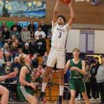 Solomon Sheppard makes a towering rebound against Port Angeles.