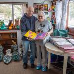 Sequim Gazette photo by Emily Matthiessen
Jeff Pogue has written approximately 3,000 love notes to his beloved wife Cathy Biedler over the 25 years of their relationship. Biedler, too, has a creative streak. Behind them are statues that she painted.
