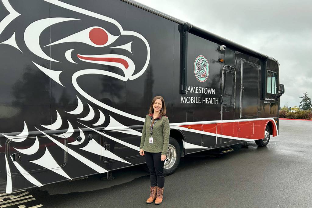 Sequim Gazette file photo by Matthew Nash/ Molly Martin, executive director of the Jamestown Healing Clinic, stands by its the mobile medical unit in 2024. It offers medication-assisted treatment and wrap-around services in Clallam Bay on weekdays for 30-40 patients.