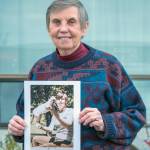 Sequim Gazette photo by Emily Matthiessen
Emma Amiad holds a picture of herself and dearly loved Siamese cat Princess dated May, 1971. Amiad recently recollected a camping tale involving Princess and an encounter with a bear for the audience of Januarys Out Loud Story Slam in Sequim.