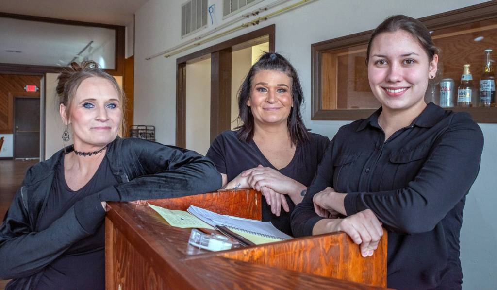 Waitresses Sheena Shroder and Michelle Brianne Steward, along with hostess Zipporah Neathery, smile as they wait for customers to arrive at the new Paradise Cafe.