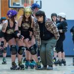 Sequim Gazette photo by Emily Matthiessen/ Skaters for roller derby team Scandals practice a drill. Coach Tia Barraza, right, shows the offensive player, or jammer, Jaden Friedle, behind, to get through the blocking wall of defensive players Stephanie Lindquist, left and Brittney Vincent, middle.