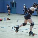 Sequim Gazette photo by Emily Matthiessen/ Olivia Wray, aka Small Fry, practices her roller derby skills. According to Port Scandalous community outreach liasonMadelyn Doffing, skaters are practicing a footwork drill, balancing on one foot then jumping to the other while maintaining balance. The form were aiming for here closely resembles the one footed stance after you throw a bowling ball down the lane.