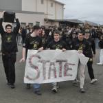 Sequim Gazette photo by Matthew Nash/ Sequims state bound wrestlers walk with a banner and speaker on Feb. 20 before embarking to the 2A state tournament.