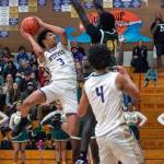 Sequim Gazette photo by Emily Matthiessen/ Solomon Sheppard looks for a shot over a Foss player on Feb. 19.