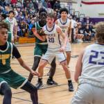 Sequim Gazette photo by Emily Matthiessen/ Zeke Schmadeke looks to pass to Mason Rapelje and Jericho Julmist in a home playoff game against Foss.