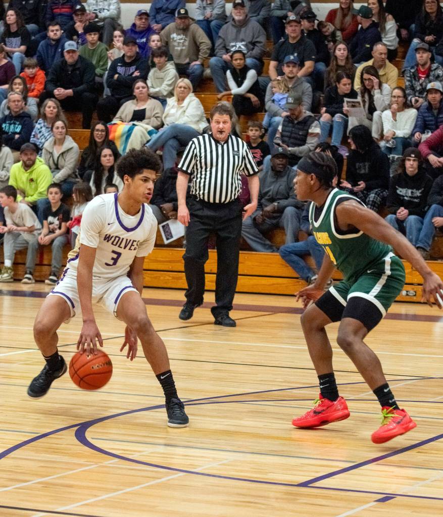 Sequim Gazette photo by Emily Matthiessen/ Solomon Sheppard looks to drive on Feb. 19 in a playoff win over Foss.