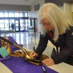 Sequim Gazette photo by Matthew Nash/ Sequim School board director Maren Halverson signs a shovel on Feb. 21 that district officials will use in groundbreaking ceremonies for different construction bond projects. District officials celebrated the special election being certified and a construction bond and Education Programs & Operations levy passing.