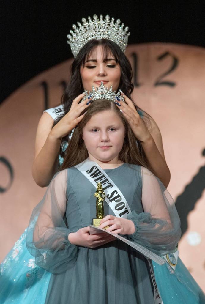 Sequim Gazette photo by Emily Matthiessen/ Outgoing Irrigation Festival queen Ariya Goettling crowns junior royalty princess Briella Gleason at the scholarship pageant on Saturday Feb. 22.