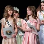 Sequim Gazette photo by Emily Matthiessen/ Madelyn Davis and Savannah Fuller exchange glances as they wait to read essays about their experience of Sequim and then be crowned junior princesses during the Irrigation Festival Royalty Pageant on Feb. 22.