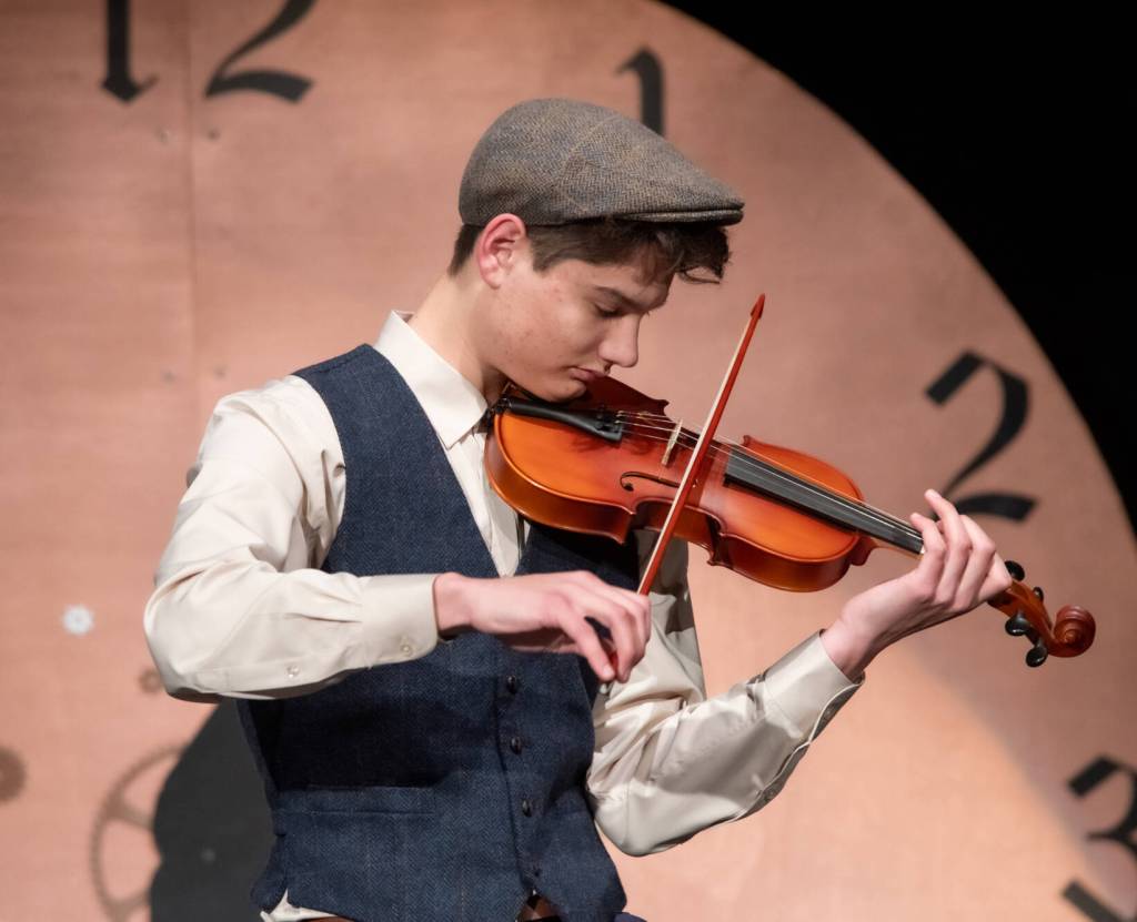 Sequim Gazette photo by Emily Matthiessen/ Sequim Irrigation Festivals scholarship pageant contestant Malachi Byrne plays Jay Ungers Ashokan Farewell onstage before a full audience at the high school auditorium.