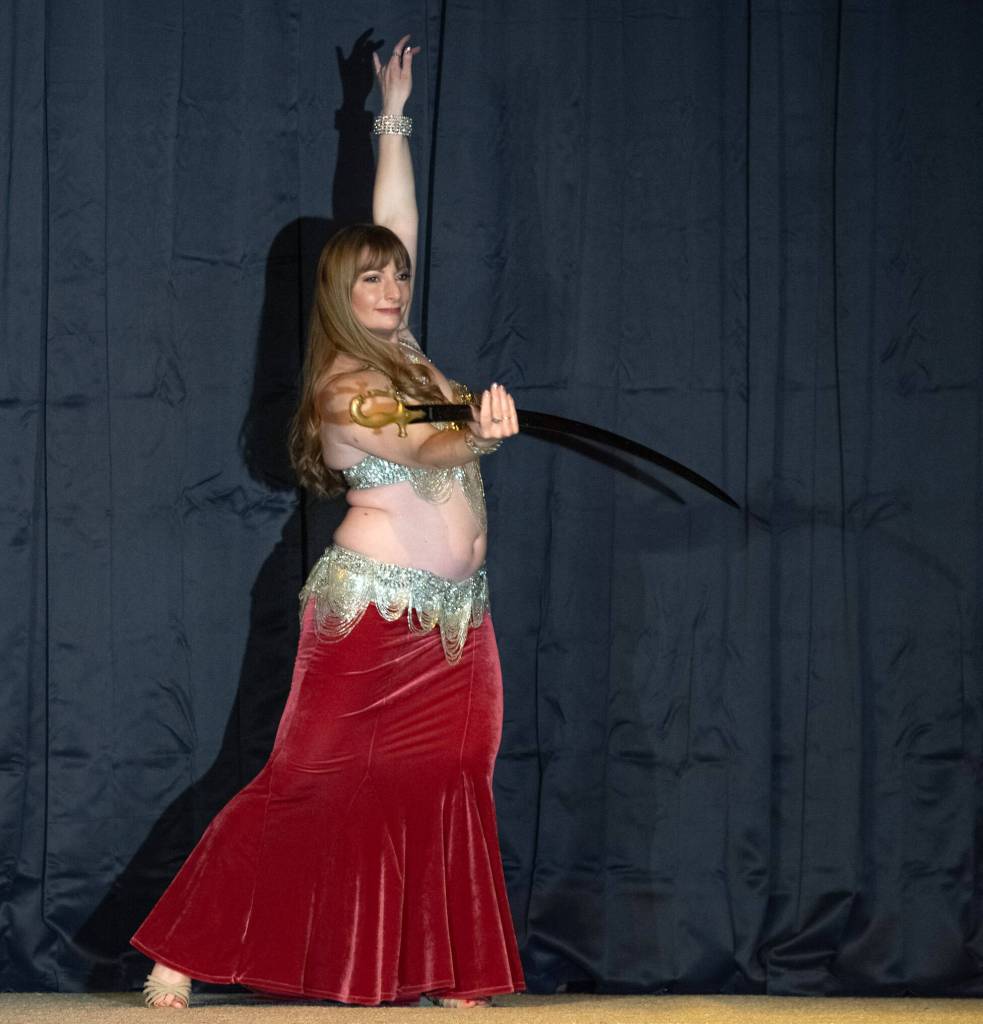 Sequim Gazette photo by Emily Matthiessen/ Sequim resident Laura Samperi-Ferdig dances with a sword at Studio Bob in Port Angeles on Feb. 21. Known as Talia in the belly dancing world, Samperi-Ferdig has studied the art since she was 8 and has taught since she was 16.