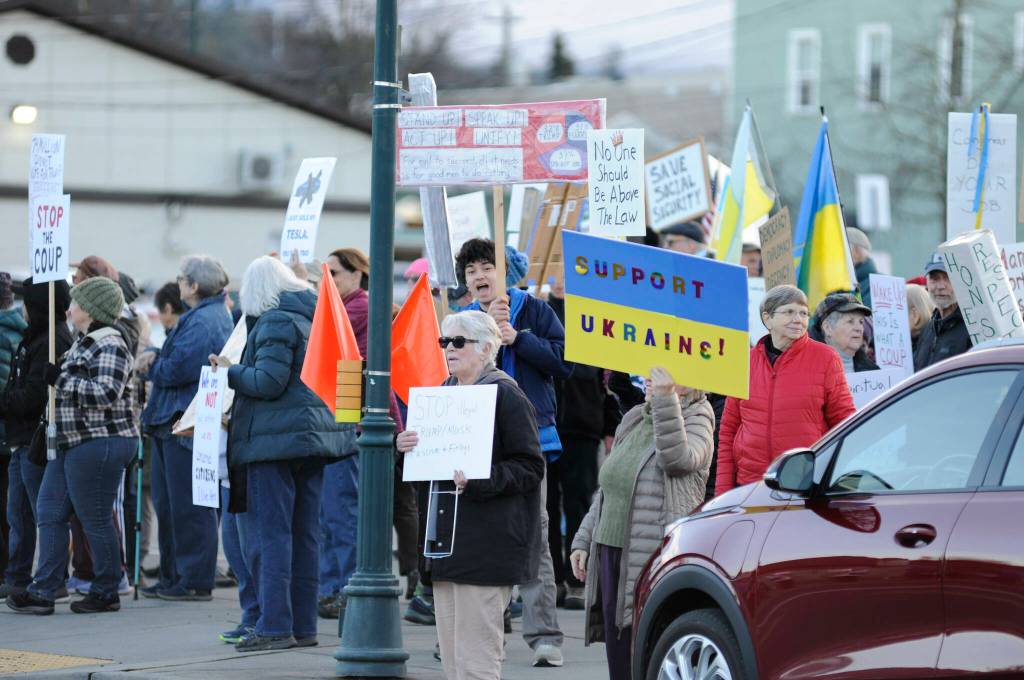 Sequim Gazette photo by Matthew Nash/ Locals gathered on March 4 to oppose federal cuts to local programs and staff, and proposed cuts to programs like Medicaid. Many also had signs in support of Ukraine in its fight against Russia.