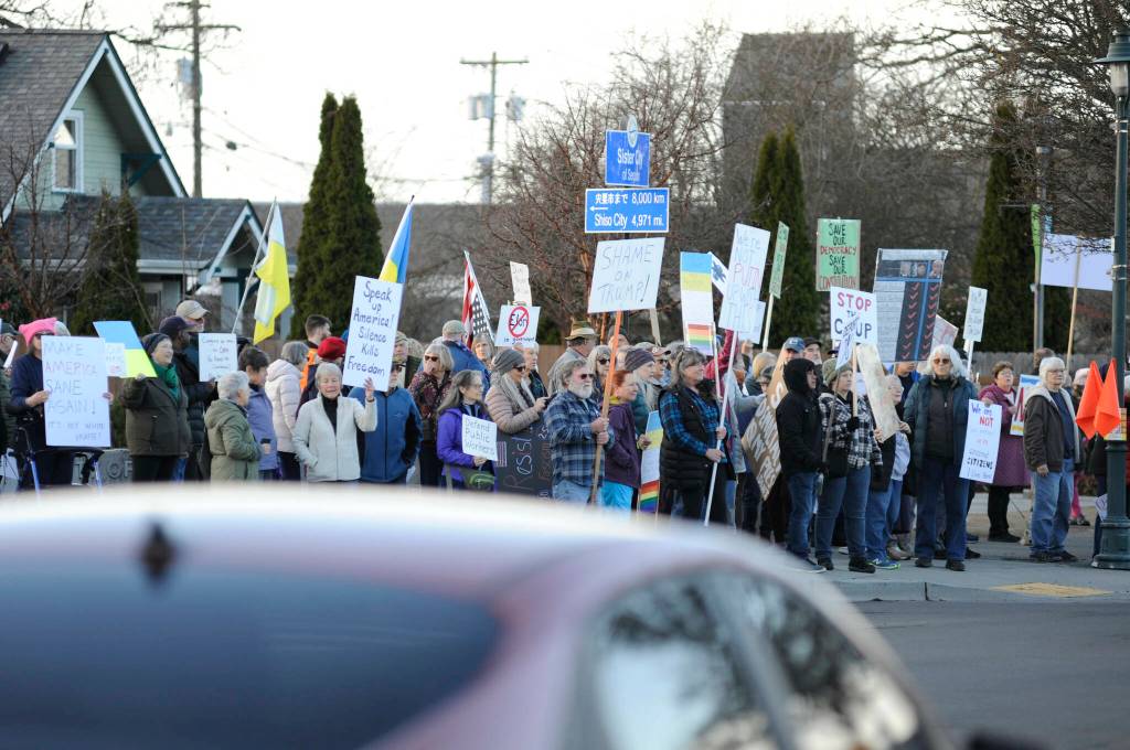 Sequim Gazette photo by Matthew Nash/ Locals gathered on March 4 to oppose federal cuts to local programs and staff, and proposed cuts to programs like Medicaid. Many also had signs in support of Ukraine in its fight against Russia.