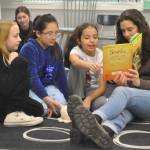 Sequim Gazette photos by Matthew Nash
Sequim High Schooler Laila Sundin reads about snakes with Helen Haller Elementary third graders, from left, Avery White, Leah Santiago Gallegos and Amber Brestoff on March 7.