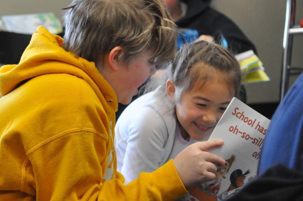 At Right: Damien Enges and Alyx Smith share a laugh while reading an Arthur book at Greywolf Elementary for Read Across America Day in Sequim.