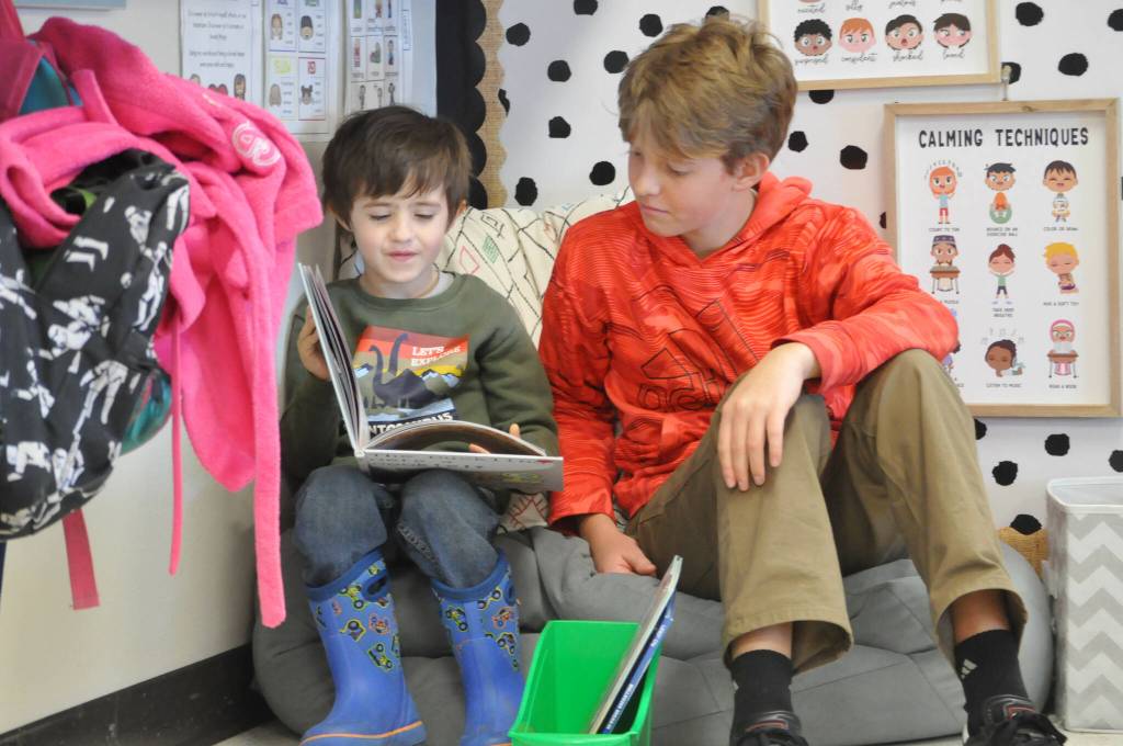 Sequim Gazette photo by Matthew Nash/ Kindergartener Keiran Bandy reads The Duckling gets a cookie? to eighth grader Bento Sellmeyer on March 7.