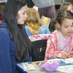 Sequim Gazette photo by Matthew Nash/ At Greywolf Elementary for Read Across America Day, eighth grader Alex Gonzalez-Adams and second grader Moriah Nash read together some Dr. Seuss books.