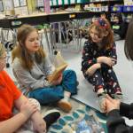 Sequim Gazette photo by Matthew Nash/ Fourth grader Ruby Sly-Hobson, second from left, reads a portion of her book to, from left, Marley Dockery, Kira Hodge and Sequim High senior Mattea Brilhart on March 7 for Sequims Read Across America event.