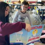 Eighth grader Annalise Castelletti reads Archie the Daredevil Penguin to kindergarteners Jesse Maas and Ivory Lyckman at Greywolf Elementary for Sequims Read Across America event on March 7.