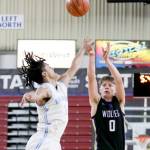 Photo by Dylan Wilhelm, Daily Chronicle/
Sequims Ethan Melnick shoots a three over Dalton Stevens outstretched hand during Sequims 69-59 loss to Mark Morris in a Round of 12 game at the 2A State Tournament at the Yakima Valley SunDome on March 5.