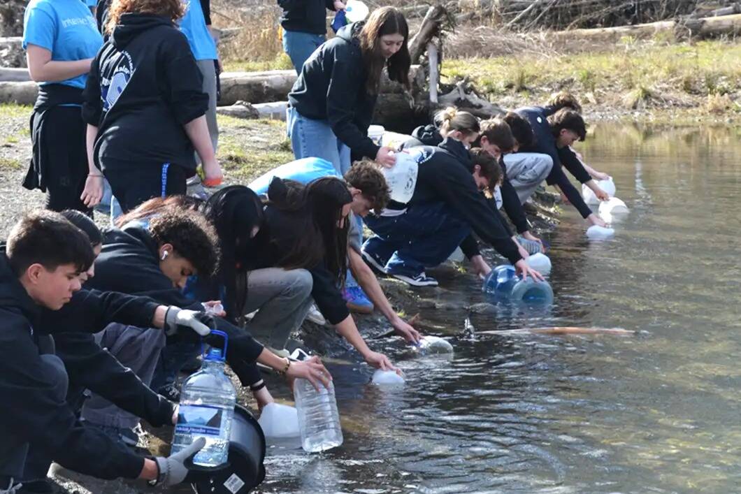 Photo by John Pehrson
Interact Club members fill jugs and buckets in the Dungeness River for the annual Walk for Water event on March 1. They walk about four miles roundtrip to symbolize how far some people must go for drinking water. They raised more than $5,000 to help build a well in a Ghana village.