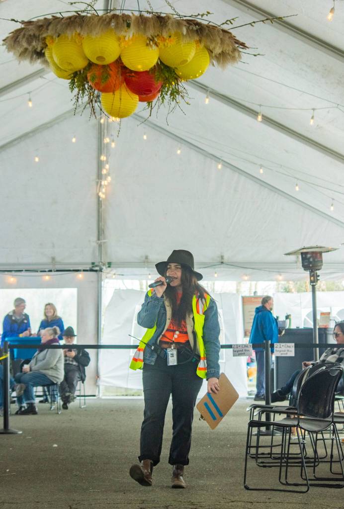 Sequim Gazette photo by Emily Matthiessen/ Emma Jane Garcia introduces a band in the Entertainment tent at Sequims Sunshine Festival on Sat.
