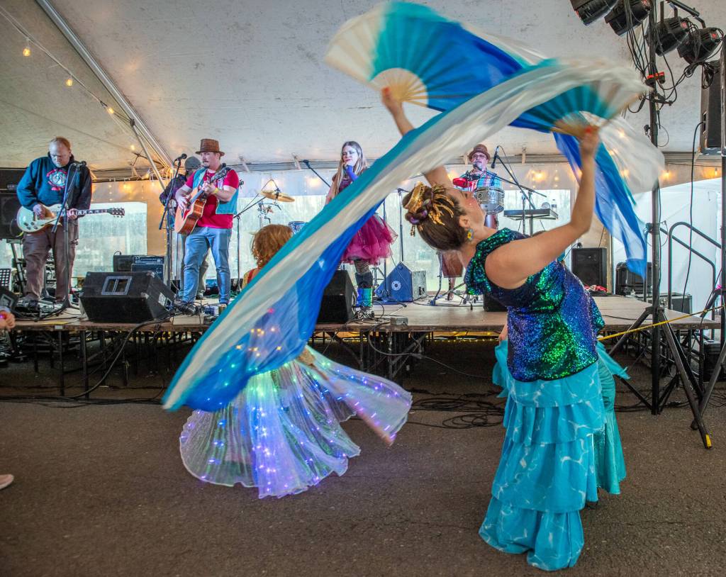 Sequim Gazette photo by Emily Matthiessen/ Cameron Quinn dances with the tunes of Kalan Wolfe and the Shift in the Entertainment Tent at the Sunshine Festival.