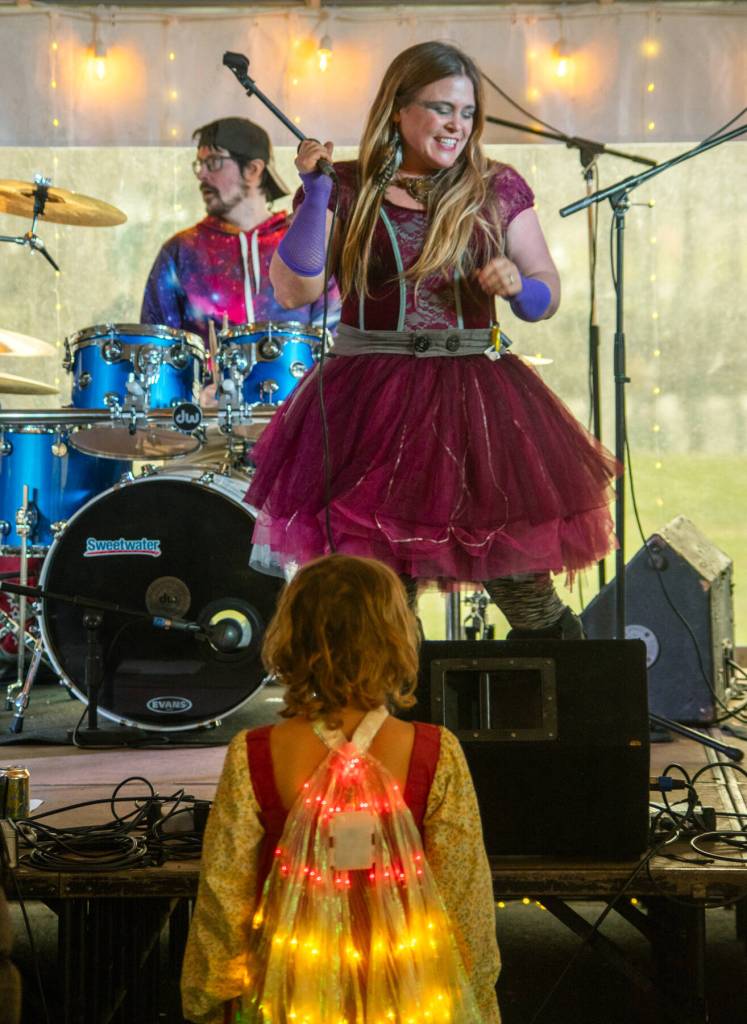 Sequim Gazette photo by Emily Matthiessen/ A young dancer watches Keely Crow-Ka of Kalan Wolfe & The Shift in the entertainment tent during the Sunshine Festival.
