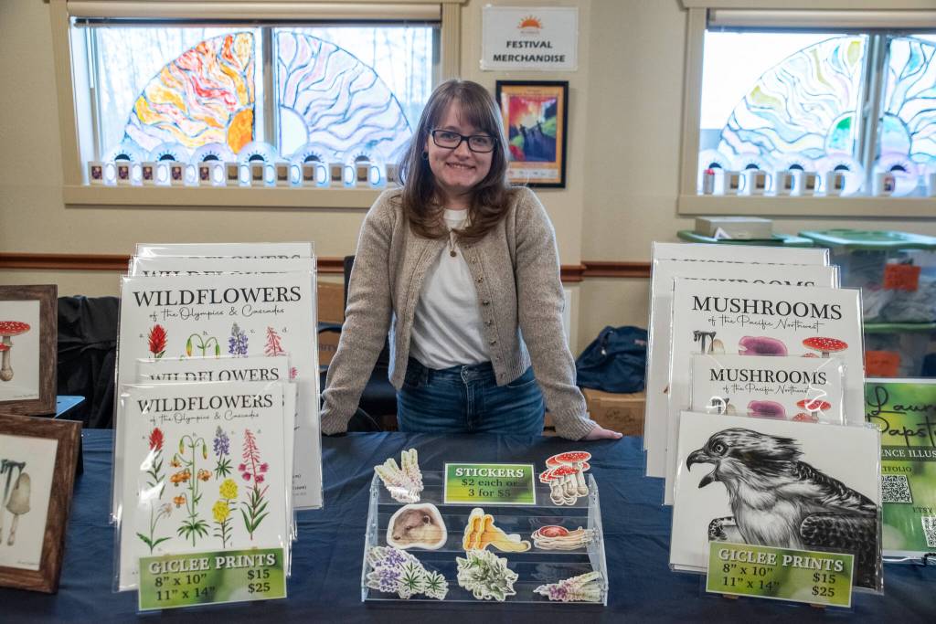 Sequim Gazette photo by Emily Matthiessen/
2025 Sunshine Festival poster artist Laura Papstein shares some of her art with visitors to the Guy Cole Center. For more of her art, go to <a href="https://lauragleasonart.com/." target="_blank">lauragleasonart.com</a>.