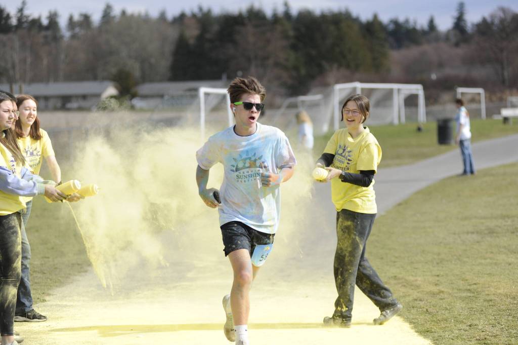 Sequim Gazette photo by Matthew Nash/ Jackson Laboy makes his way through the final stretch of the 5K Sun Fun Color Run with a first place finish for all runners.