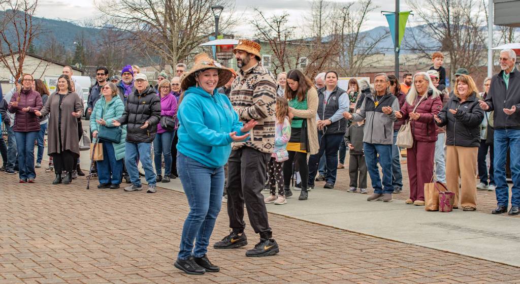 Sequim Gazette photo by Emily Matthiessen/  Jamestown S'Klallam tribe members teach the crowd at Sequim's Sunshine festival opening ceremony at the civic center the moves of the Hooya Hooyay dance.