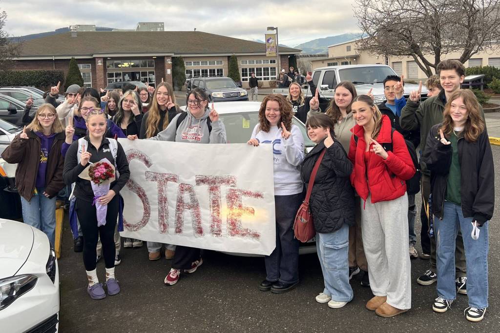 Photo courtesy Port Angeles/Sequim Gymnastics Team/ Friends and family celebrate Lucy Spelker, front left, going to the 1A/2A/3A Gymnastics State Meet in February.