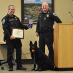 Sequim Gazette photo by Matthew Nash
Sequim Police Chief Mike Hill, right, presents canine officer Mamba and her handler Paul Dailidenas a Distinguished Service Medal for their seven-plus years of patrolling Sequim. Mamba was retired from service and will live with Dailidenas family. Dailidenas will continue patrol and as a field training officer.