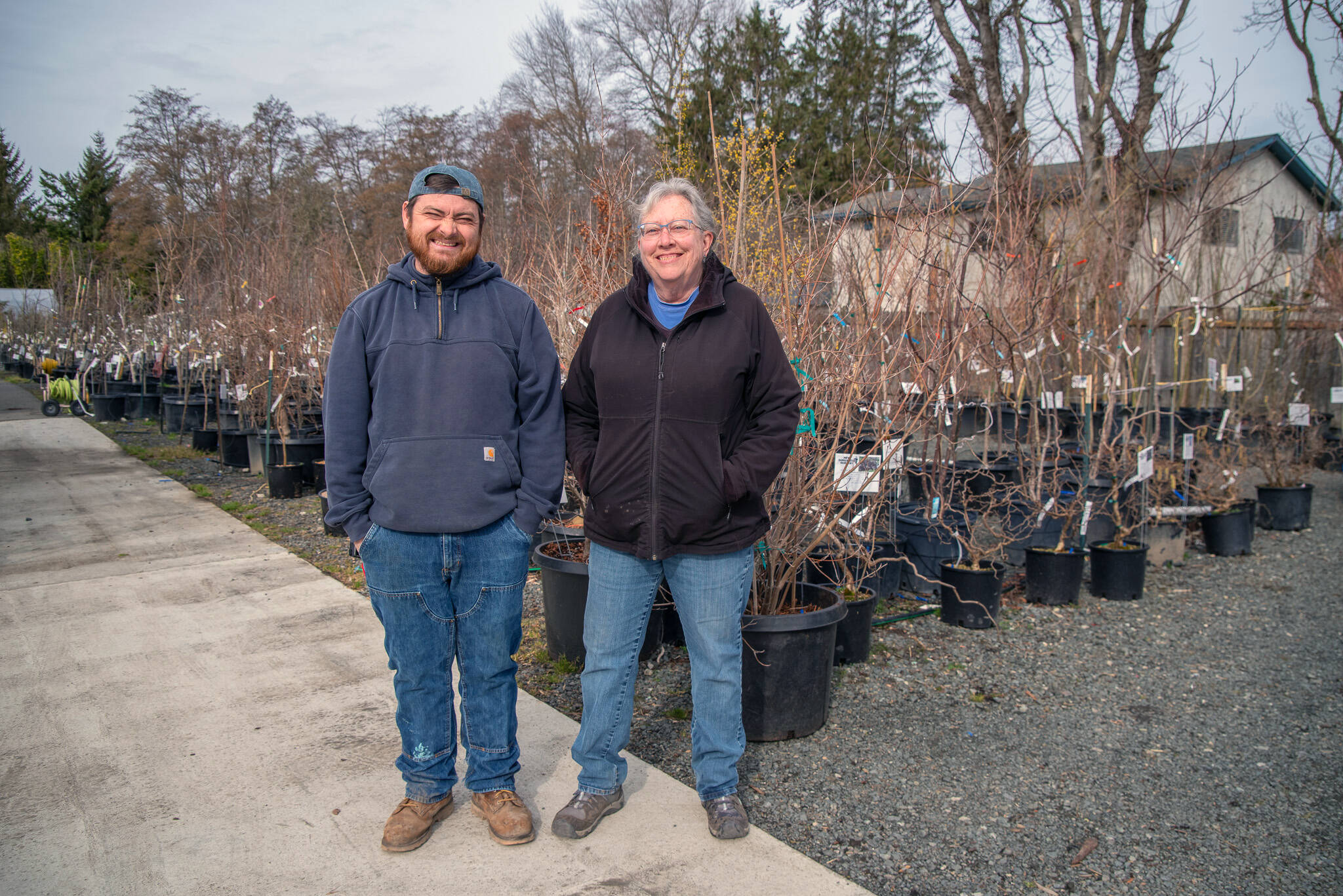 Sequim Gazette photo by Emily Matthiessen
Stew Cockburn and the longest tenured employee of New Dungeness Nursery Garden, Kathy Saffold, head of labeling, pause to talk shop. Saffold worked at McCombs Nursery before it closed and delights in guiding customers to the perfect plant for their circumstances.