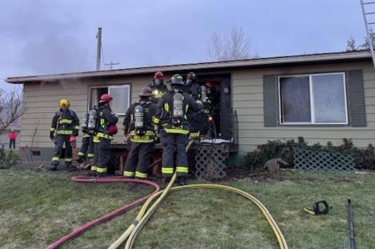 Photo courtesy Chris Turner for CCFD3 
Neighbors and Clallam County Fire District 3 firefighters helped rescue a woman and three dogs on March 14 from a house fire in the City of Sequim.