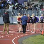 Sequim Gazette photo by Matthew Nash 
Athletes, coaches and volunteers ready for the girls 4X200 meter on March 20 in the first race on the resurfaced track for Sequim School Districts stadium. Sequim had not hosted meets since March 2021 due to deteriorating conditions of the track.
