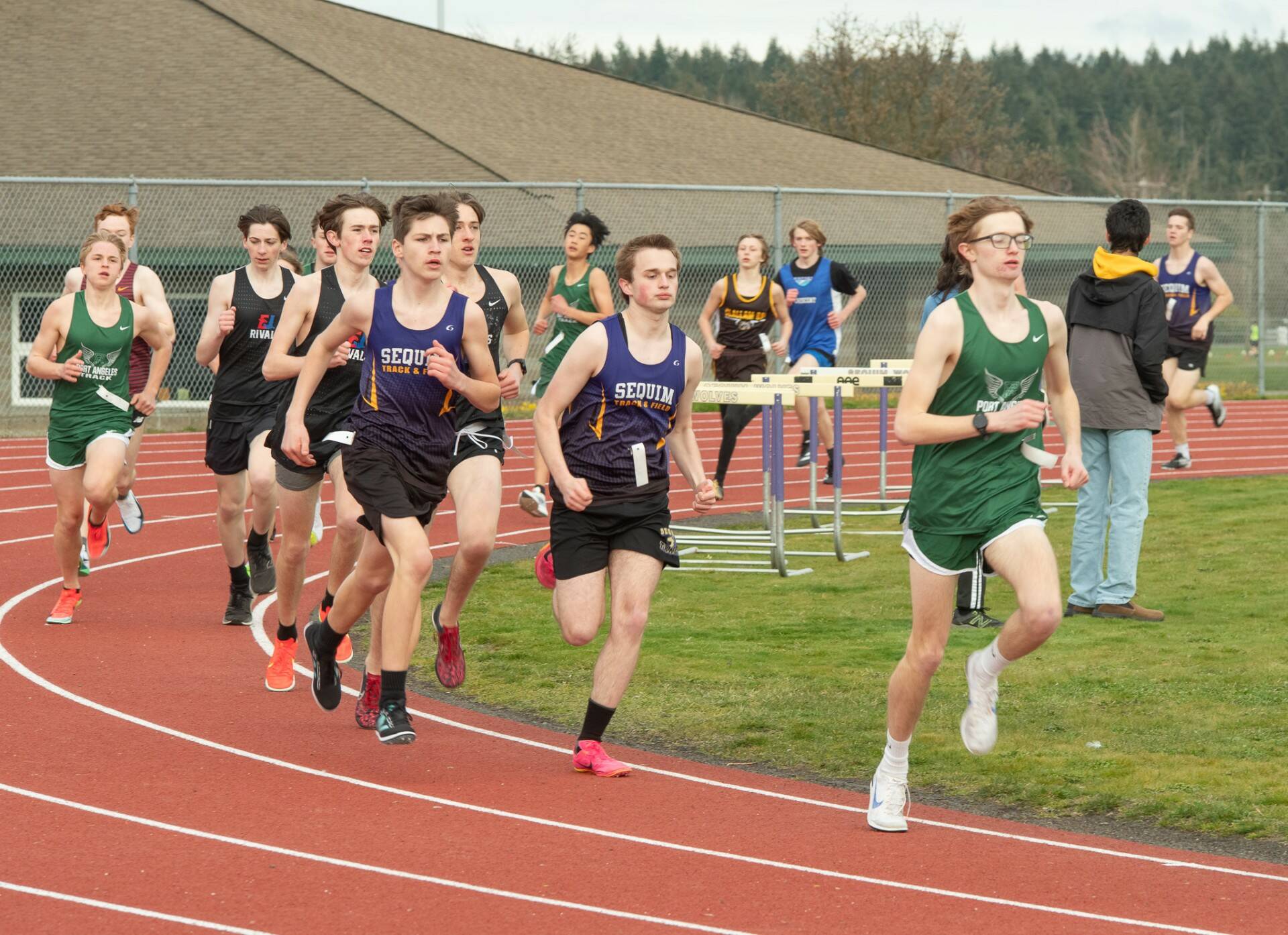 Sequim Gazette photo by Emily Matthiessen
Port Angeles Easton Dempsey, front, leads a pack of runners from Sequim, East Jefferson, Port Angeles, Clallam Bay and Crescent in the 1600 meters race on March 20 in Sequim.
