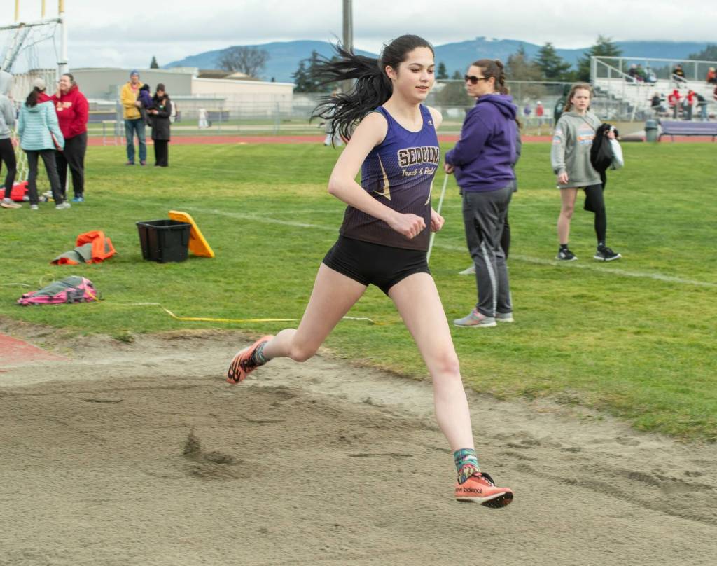 Sequim Gazette photo by Emily Matthiessen/ Sequims Clare Turella makes a run during a jump at a March 20 track meet.
