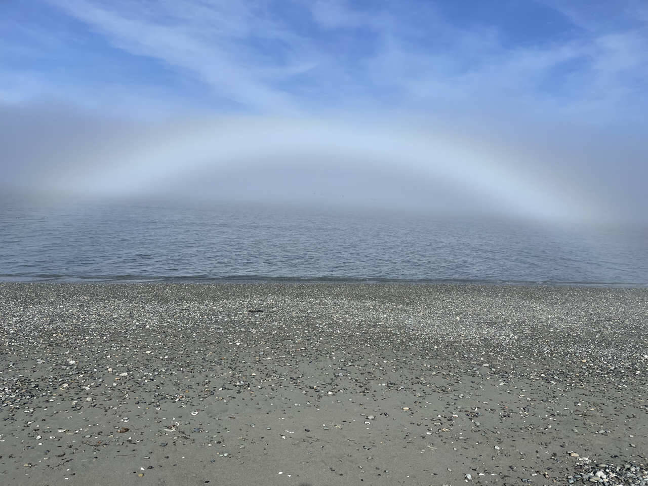 Photo by Sandy Reed| Reader Sandy Reed submitted this photo of a fog bow that she snapped while walking along Graysmarsh Beach late Tuesday afternoon, March 25. A fog bow is different from a rainbow because fog droplets are much smaller than raindrops, which minimizes color and makes the bow appear white. Reed said that although it was sunny in Sequim, the Strait of Juan de Fuca was shrouded in thick fog. Suddenly, the sun broke through and formed a fog bow. This one literally shimmered! she wrote in an email to the Sequim Gazette.