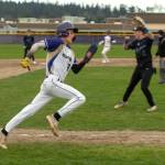 Sequim Gazette photo by Emily Matthiessen/ Ethan Staples makes a play for home on March 26 during a game at home against North Mason. He had two runs in the 8-7 Wolves win.