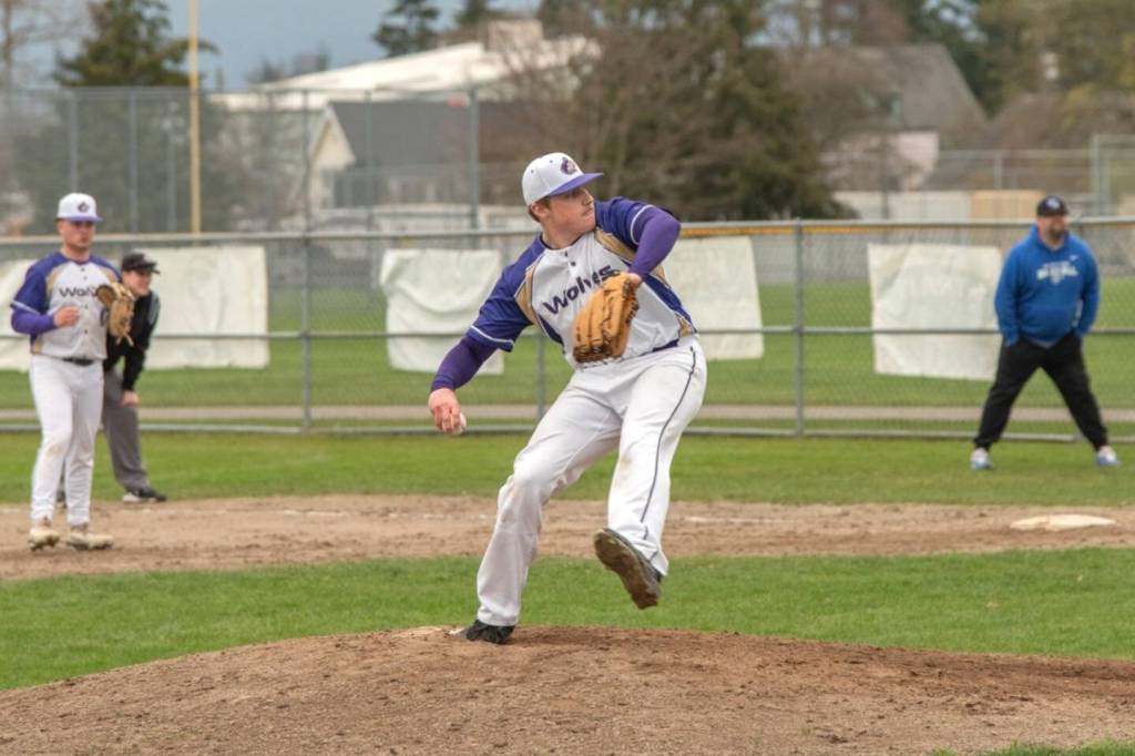 Sequim Gazette photo by Emily Matthiessen/ Braydan White makes a throw in two innings of work on March 26 with three strikeouts to help the Wolves win 8-7.