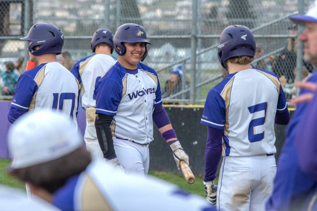 Sequim Gazette photo by Emily Matthiessen/ Sequims Duran Ward smiles as he walks into the dugout during an 8-7 win. He had an RBI to help the Wolves.