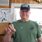 Sequim Gazette photo by Emily Matthiessen/ Featured speaker Daniel Abbott shows the Vietnam veteran lapel pin which was was given to local Vietnam veterans during Saturday's ceremony at the American Legion, Jack Grennan Post No. 62. The words "A grateful nation thanks and honors you" are embossed on the back of the pins, with an eagle set against the flag with a blue circle and laurel wreath and the words "Vietnam War Veteran" around it.