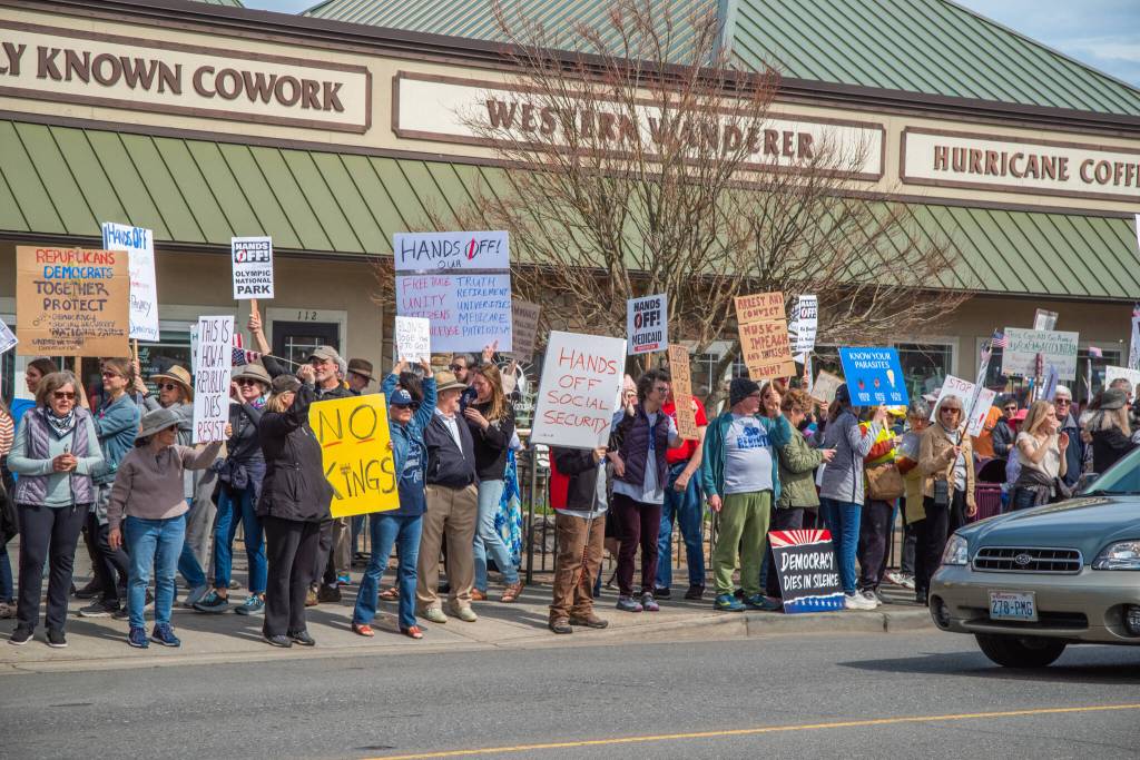 Sequim Gazette photo by Emily Matthiessen/ According to a clicker count by volunteers with Sequim Indivisible, 1298 people turned out by 11:45 a.m., with nearly 1400 people counted by 2:00 p.m. during Sequims version of the Hands Off  protests held across the nation and in other countries on Saturday. The protest was peaceful and orderly, according to police, organizers and protesters and featured a range of protest signs.