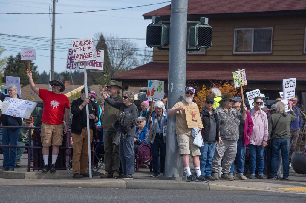 Sequim Gazette photo by Emily Matthiessen/ According to a clicker count by volunteers with Sequim Indivisible, 1298 people turned out by 11:45 a.m., with nearly 1400 people counted by 2:00 p.m. during Sequims version of the Hands Off  protests held across the nation and in other countries. The protest was peaceful and orderly, according to police, organizers and protesters.